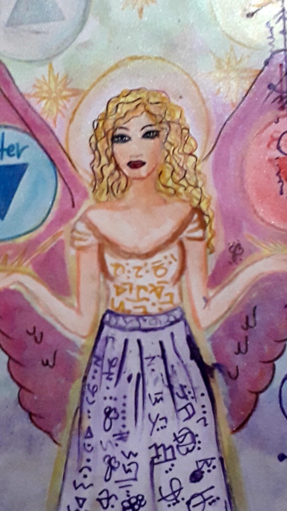 Close detail of the winged figure: gold halo, curled hair, and a long skirt covered in inked symbols.